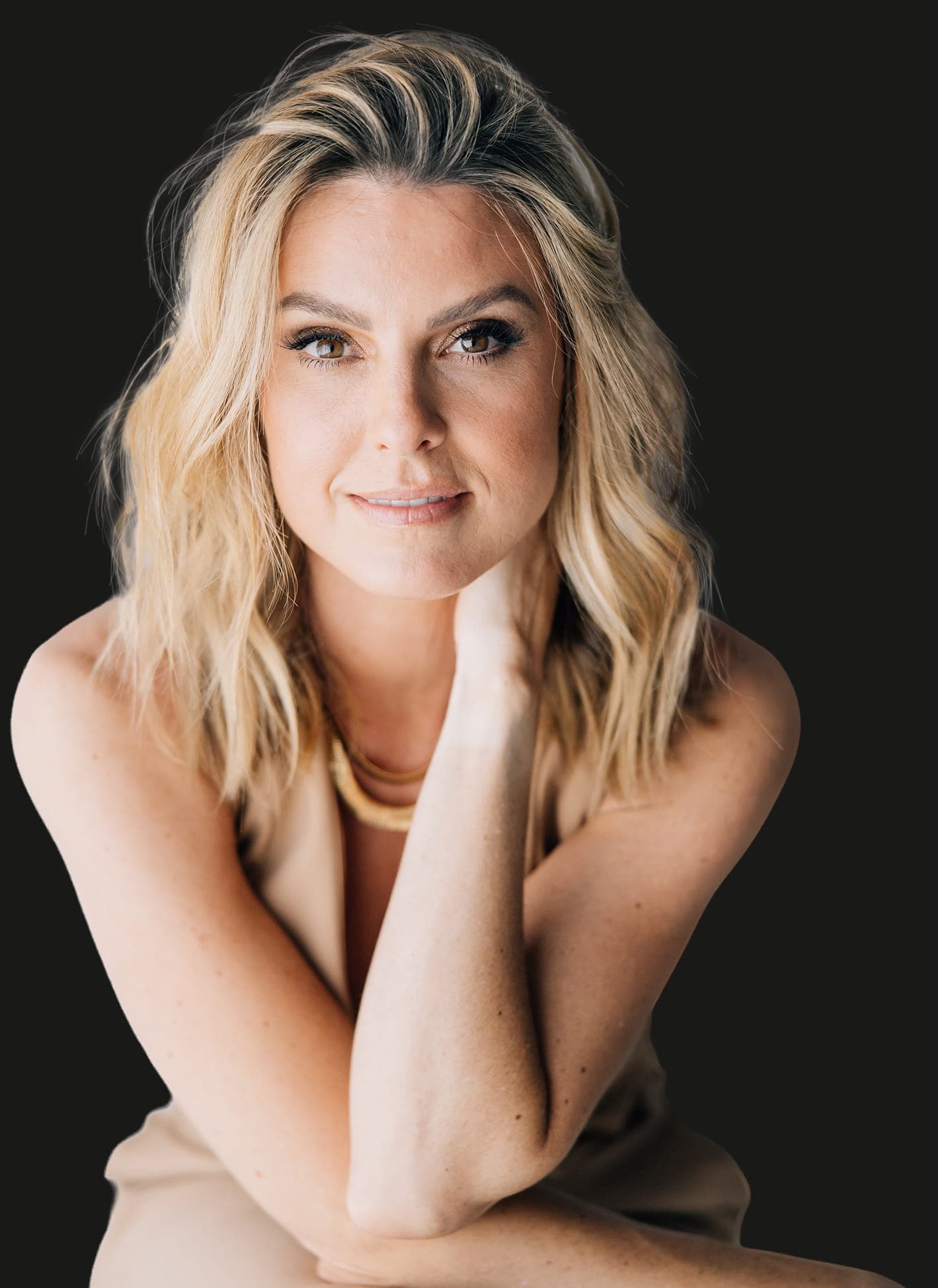 Close-up portrait of Keeli against a dark studio background.