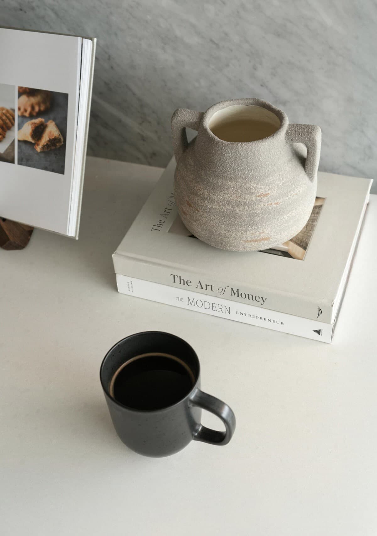 Woman sitting by window with coffee.